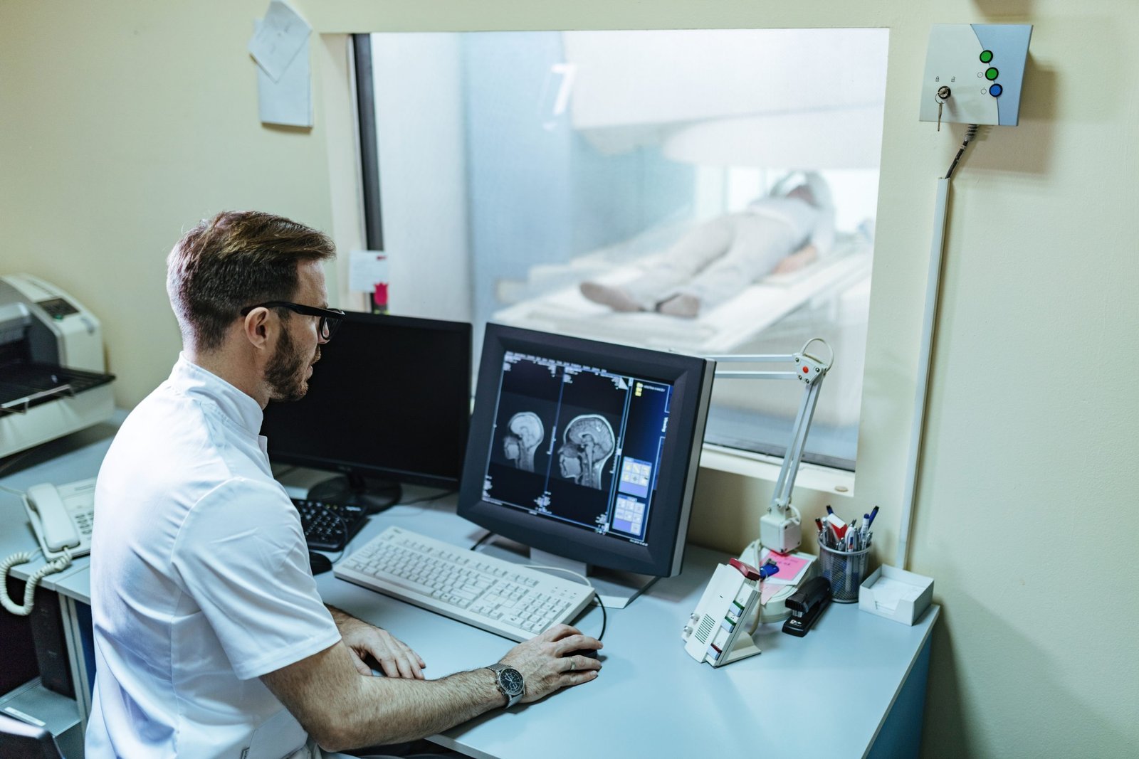 male radiologist analyzing mri scan results patient computer monitor control room1 scaled
