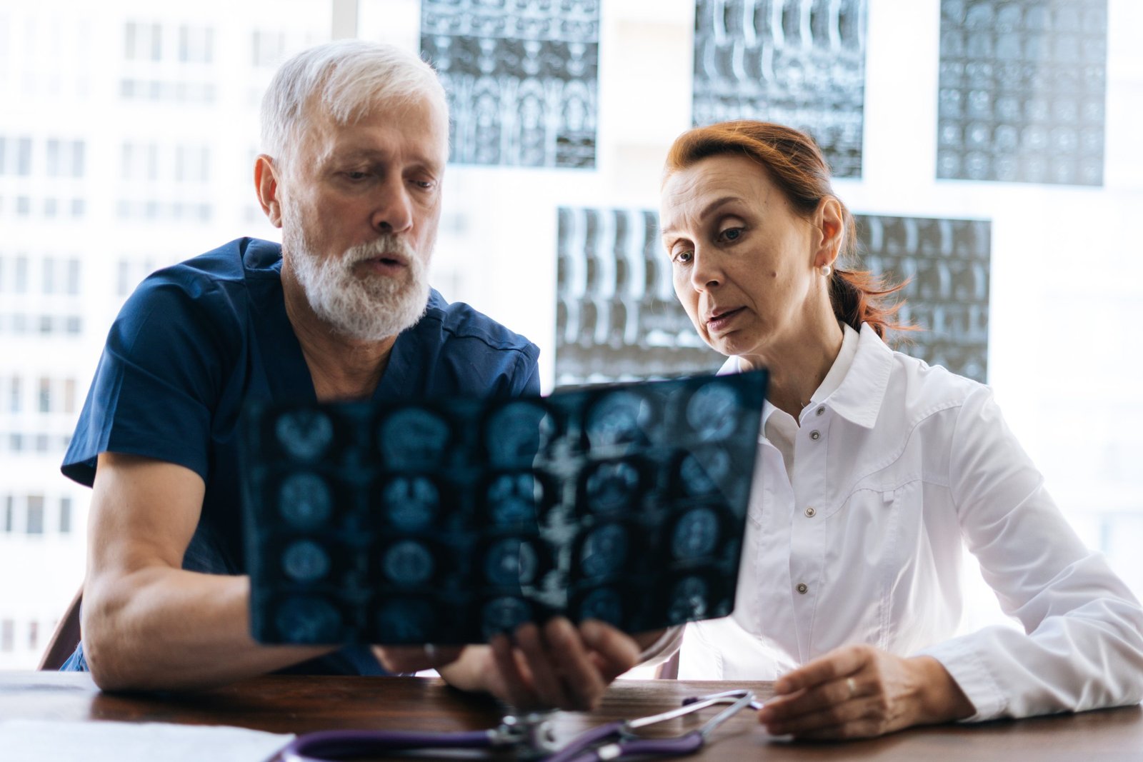 professional doctor nurse examining together history disease patient using mri scan head background panoramic window with xray mri scans concept medicine health care scaled